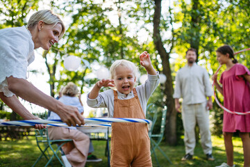 Fototapeta premium Family enjoying outdoor summer gathering with playful activities.