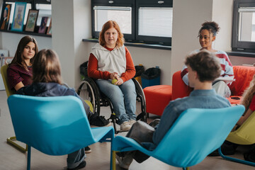 Teen students talking together in inclusive school setting. © Halfpoint