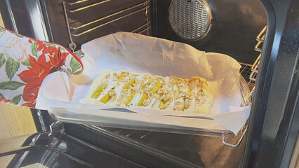 Tofu being baked in an oven with seasoning on parchment