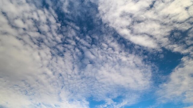 Calm sky scenery, Peaceful clouds across horizon, Gentle wind influences textured cloud formations, Azure sky displays layered cloud patterns and tranquil movement