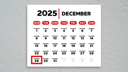 The date December 29th marked with a red cursor on the wall calendar 2025