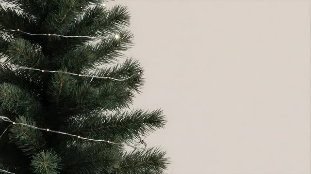 Christmas tree with tiny white lights on a light background. Close up