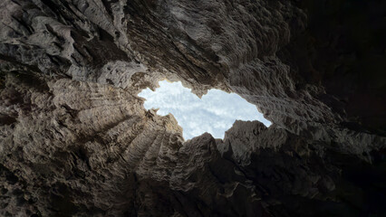 sharp cliffs, geographical formations, shaped stones and dark pits