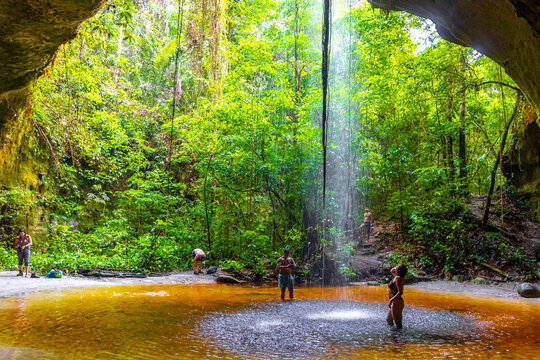 Cave and rainforest waterfall limestone rocks interior trail Amazonas Brazil.
