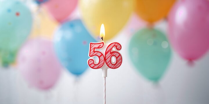Birthday candle with number 56 amid colorful balloons, emphasizing age milestone celebration