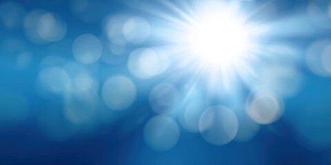 Bright sunburst in blue sky with glowing light rays and bokeh circles