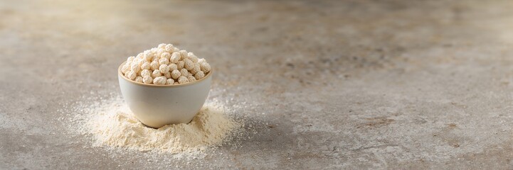 Construction worker using tablet and walkie talkie on building site, focusing on project management and communication, occupational safety awareness