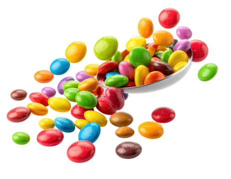 Colorful candy-coated chocolates spilling from a tilted white bowl, isolated on black