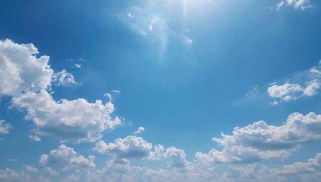 A vast blue sky with clouds, serving as a background for landscape photography, ideal for text overlay