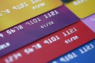 Many credit or debit cards with fictional specimen numbers. Big amount of banking plastic cards of various colors. Financial concept of business and e-commerce