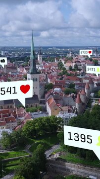 Aerial slide and pan footage of historic city center with tourist sights. Augmented reality with various symbols and rising numbers. Tallinn, Estonia