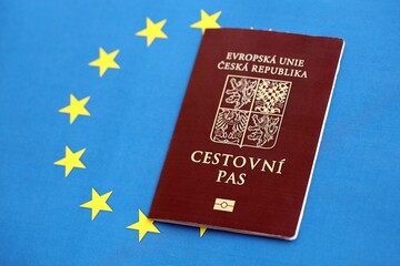 Czech biometrical passport on European Union flag background. Concept of citizenship of Czech Republic
