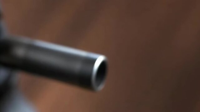 Witness the intricate details of firearm mechanics as a bullet cartridge is showcased in the chamber, followed by a close-up of the muzzle, highlighting precision and craftsmanship.