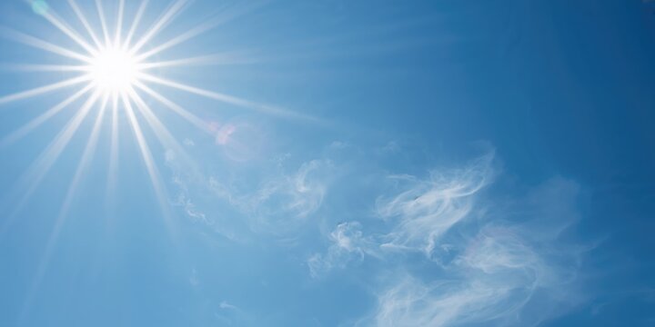 Sunlight filtering through a solar lens flare creating a vivid visual effect, ideal for background or UI design, Earth Day