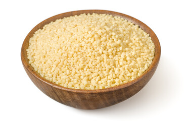 Uncooked couscous in the wooden bowl, isolated on white background.