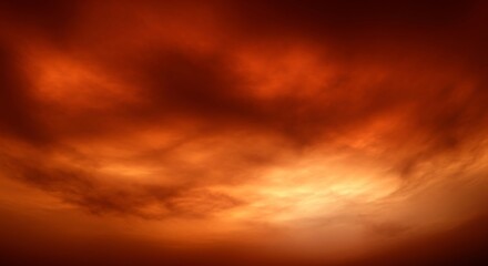 Fototapeta premium Dramatic fiery red and orange clouds in a vibrant sunset or stormy sky, creating an intense atmospheric background.