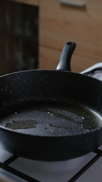 Adding chopped onion and garlic to the frying pan