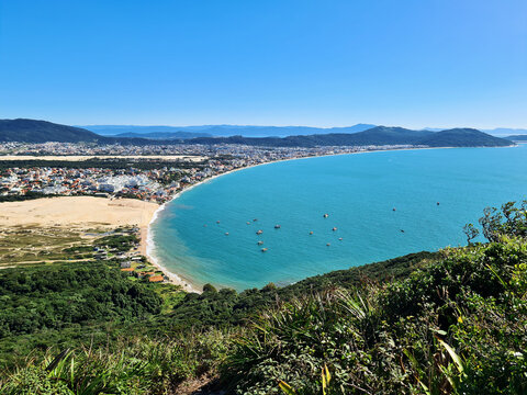 Panoramic view of Ingleses beach in Florian&oacute;polis, Santa Catarina, a beautiful ocean landscape with mountains in a restinga area and dunes seen from the top of Ingleses hill on a beautiful sunny day.	
