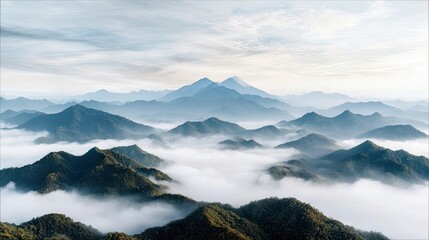 A vast landscape of layered mountains shrouded in mist, with peaks visible above the clouds. The scene is illuminated by the soft light of sunrise, creating a s