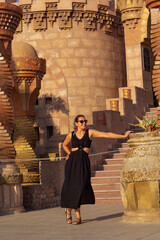 portrait of beautiful woman in sunglasses looking at camera	