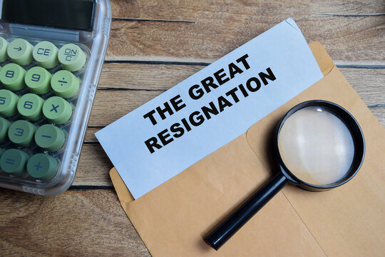 The great resignation text on document above brown envelope.