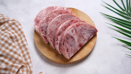 Sliced Raw Meat on Wooden Board with Tropical Leaf