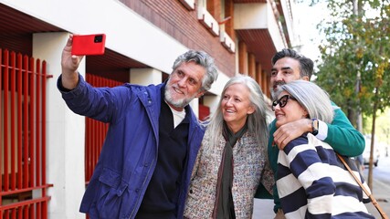 Seniors friends taking urban selfie together