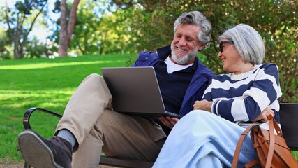 Senior couple enjoying digital connection outdoors in park