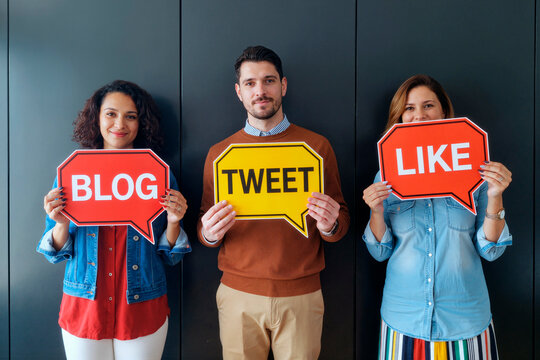 Young Multiethnic Adults Holding Social Media Speech Bubbles and Smiling
