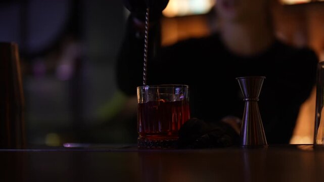 Barben Stirs Alcoholic Cocktail with a Spoon