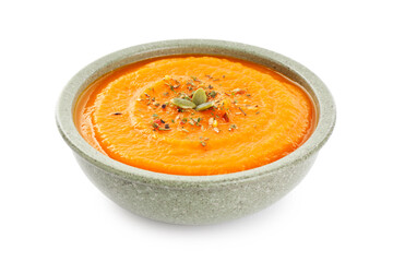 Tasty pumpkin cream soup with seeds in bowl isolated on white