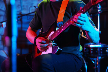 Naklejka premium Man playing electric guitar on stage, closeup