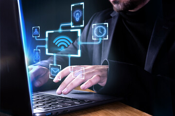 Man typing on laptop connecting with network icons