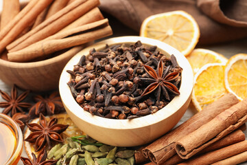 Different spices and dry orange slices for mulled wine on table, closeup