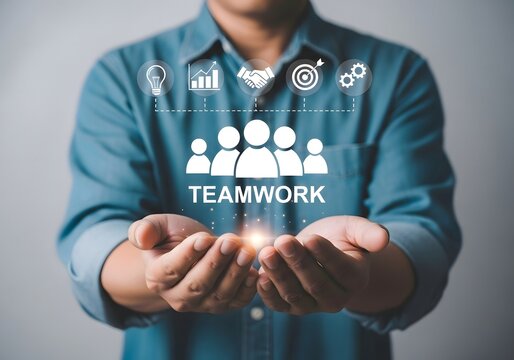 Person holding teamwork graphic with icons of lightbulb chart handshake target and gear above it - Powered by Adobe