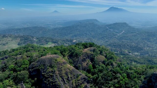 Aerial Sunrise View of Nglanggeran Ancient Volcano with Merapi Merbabu in the Background