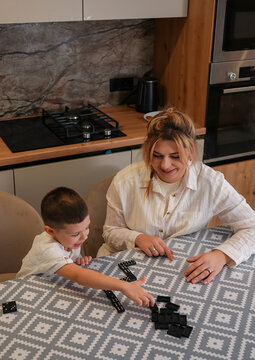 Mother and son bonding over a playful game at home