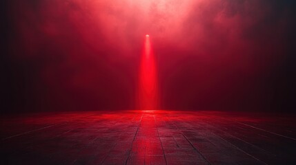Obraz premium A dramatic shot featuring a single red light illuminating a dark floor, generating a tense and unsettling atmosphere. Perfect for conveying mystery, suspense, or isolation.
