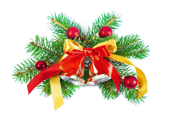 Green spruce branch with bells, bow and Christmas balls isolated on white background.