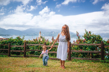 Mother and child explore a garden in Nha Trang