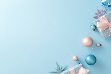 Minimalist Christmas background with pastel blue and pink ornaments. Flat lay, top view.