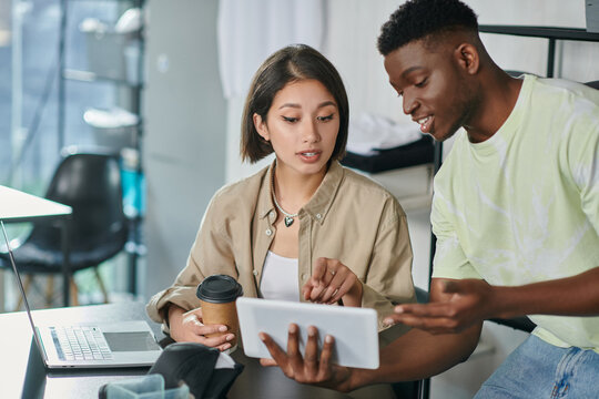 Collaboration between a young man and woman in a creative print studio