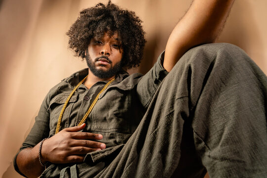 Stylish man with afro hairstyle in studio setting