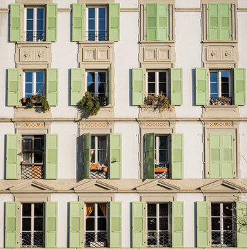 Green shutters on building facade in Lausanne