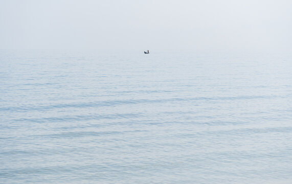 Person rowing alone on a calm Caribbean ocean
