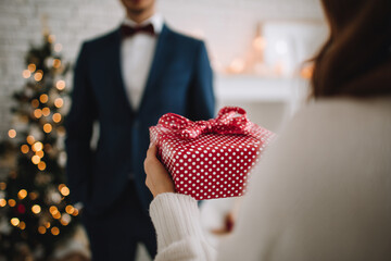 Holiday gift exchange in a cozy home setting during Christmas celebrations
