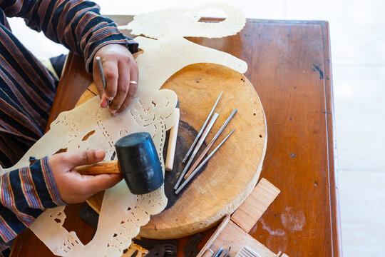 Man crafting wayang kulit in javanese traditional process