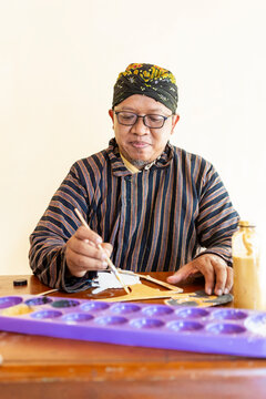 Javanese Artisan Painting Traditional Wayang Kulit Puppet