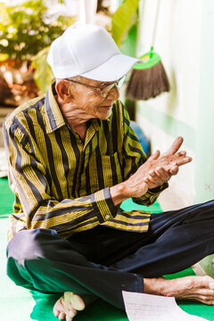 Elderly man enjoying traditional music in Java