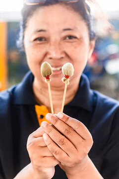 Artisan demonstrating traditional batik making tools